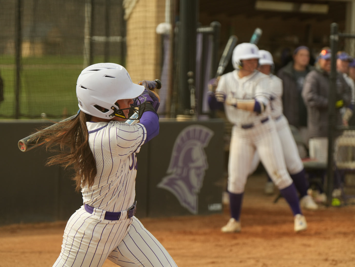 Girl athlete swinging a baseball bat