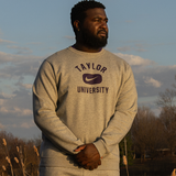 Male standing wearing Taylor University crew neck.